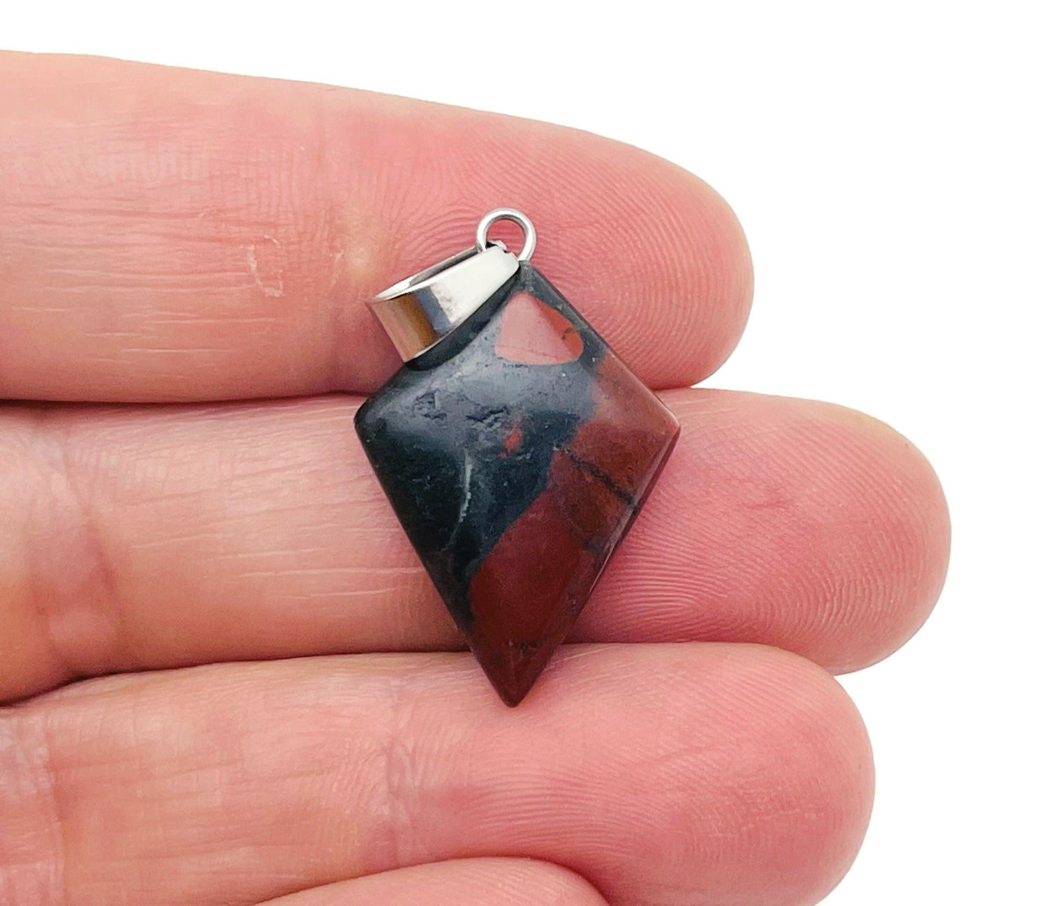 African Bloodstone triangle gemstone pendant showing a polished, geometric bloodstone pendant with a metal bail for necklace attachment.