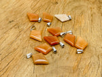 Orange Aventurine triangle gemstone pendant with geometric design, showcasing vibrant orange color and polished surface.