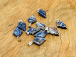 Sodalite triangle gemstone pendant by GemstoneGO featuring a geometric design and vibrant blue color.