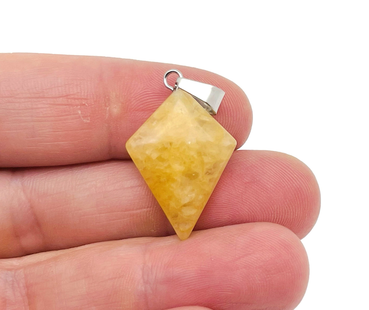 Yellow jade triangle gemstone pendant featuring geometric design, crafted by GemstoneGO, displayed against a neutral background.