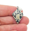 Dalmatian Jasper triangle gemstone pendant from GemstoneGO, showcasing a geometric jasper stone with black spots on a silver chain.