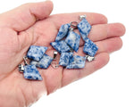 Blue Spot Jasper triangle gemstone pendant with geometric design, showcasing vibrant blue and natural stone patterns.