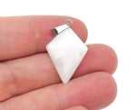 White jade triangle gemstone pendant featuring geometric design, handcrafted by GemstoneGO, on a silver chain.