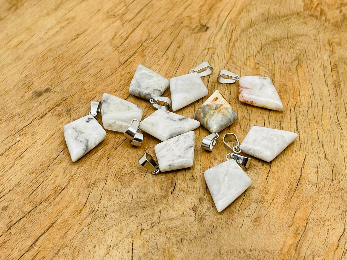 Crazy Lace Agate triangle gemstone pendant with geometric design, featuring vibrant patterns and natural stone details from GemstoneGO.
