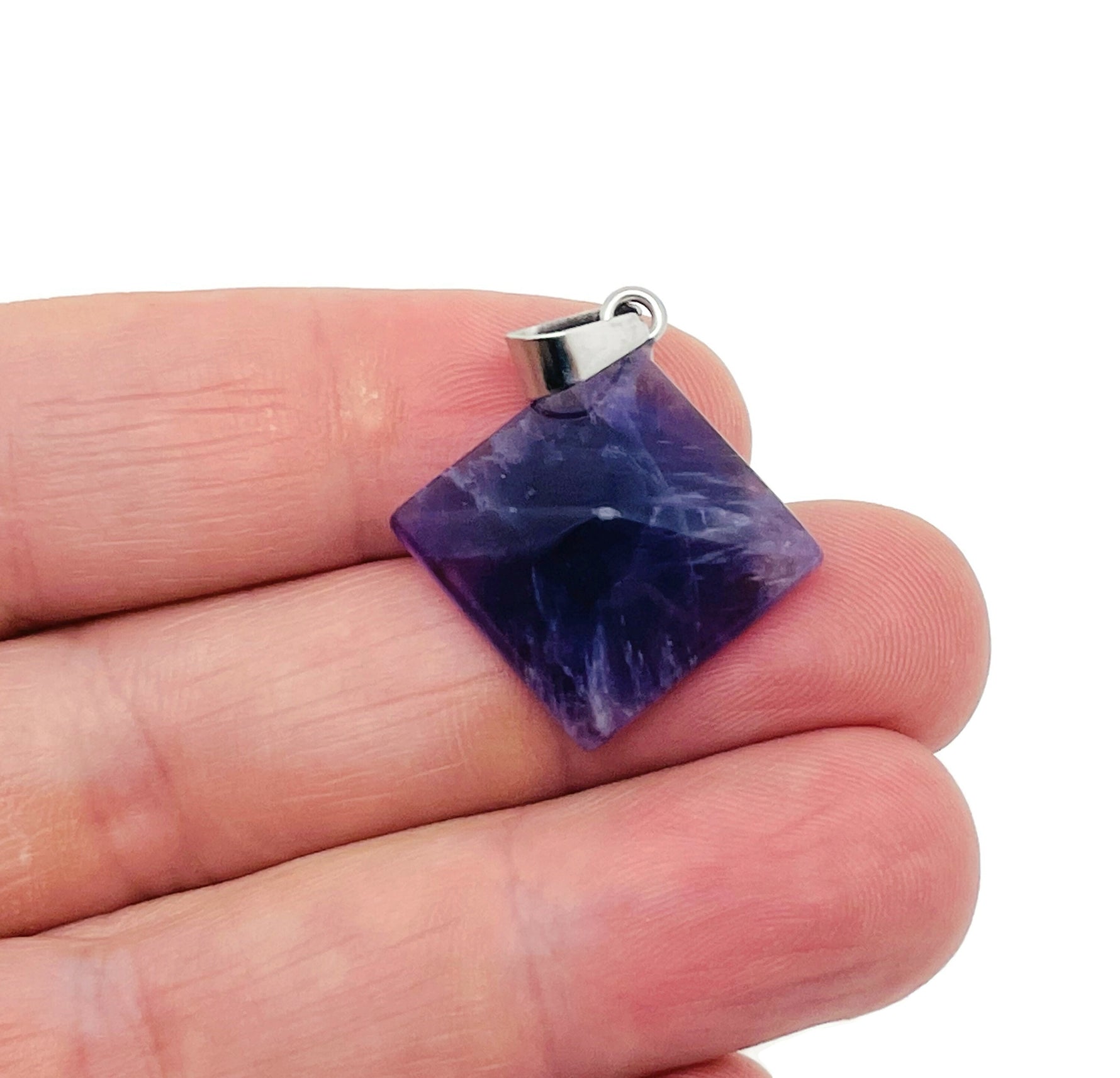 Natural amethyst pyramid gemstone pendant from GemstoneGO, showcasing a purple carved crystal jewelry piece.