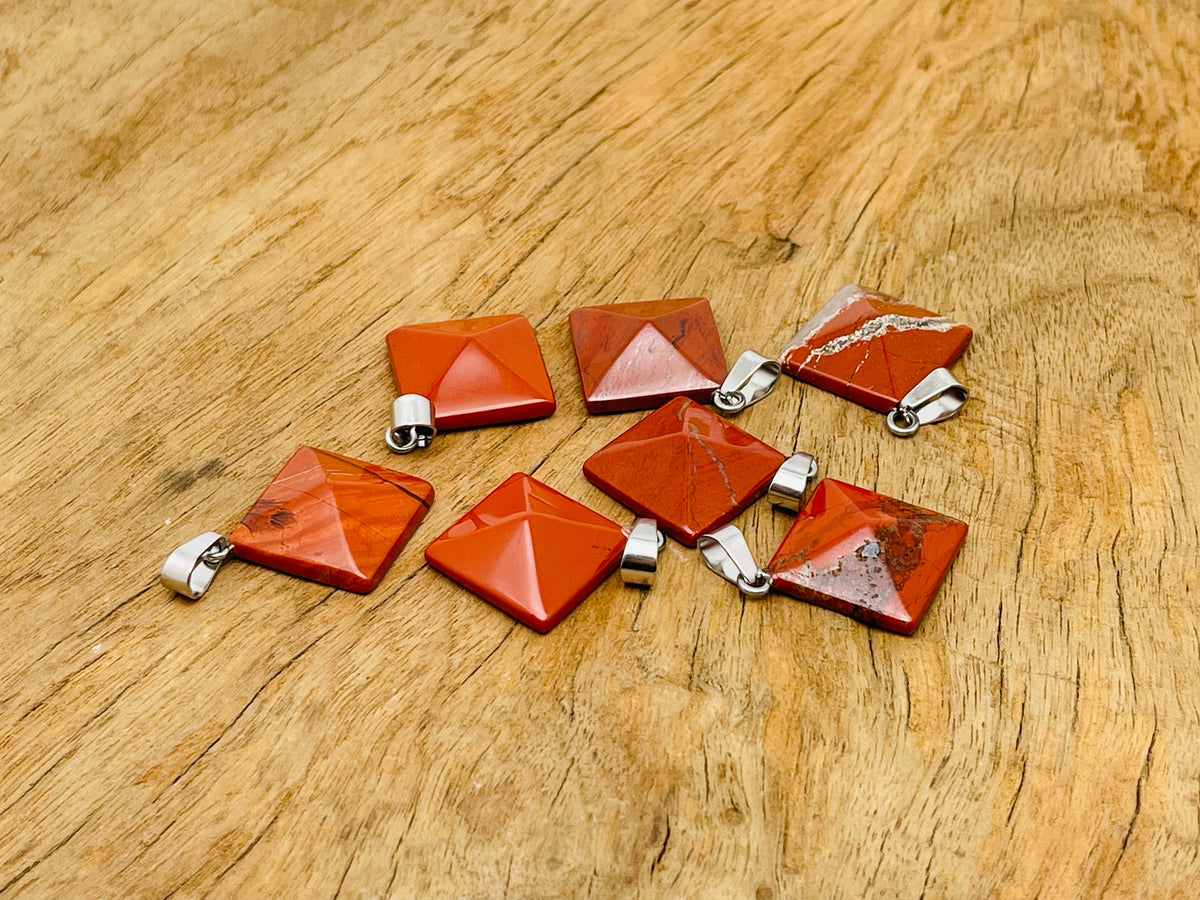 Red Jasper pyramid gemstone pendant from GemstoneGO featuring a natural red jasper stone on a silver chain.