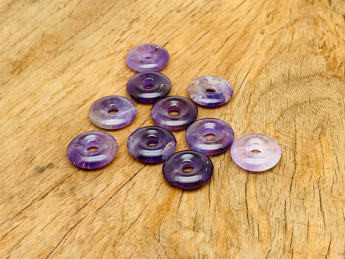 Amethyst crystal donut pendant from GemstoneGO, 20mm Pi stone with purple amethyst gemstone and polished round shape.