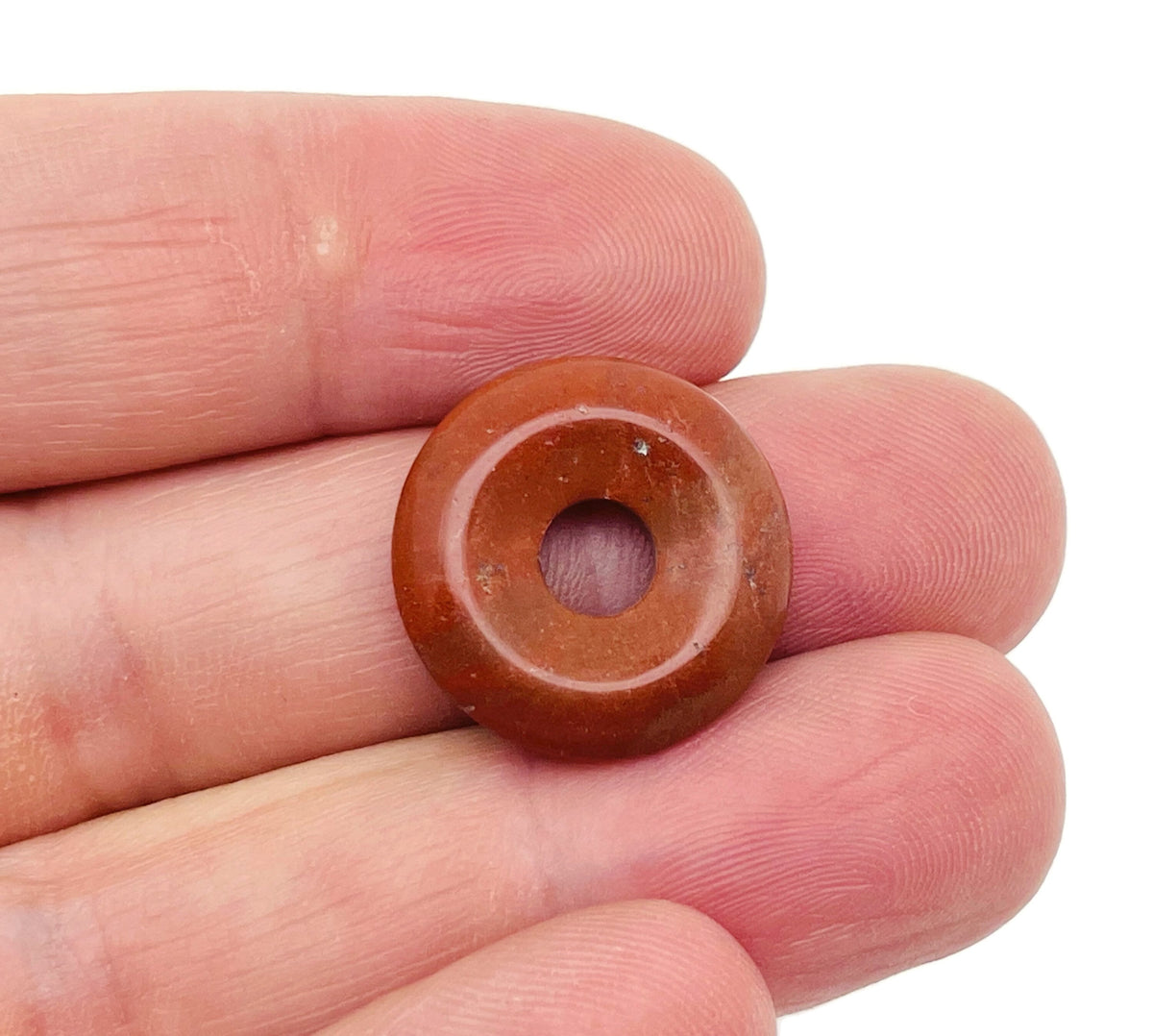 Red Jasper crystal donut pendant from GemstoneGO, 20mm Pi Stone with polished red jasper gemstone and smooth, rounded shape.