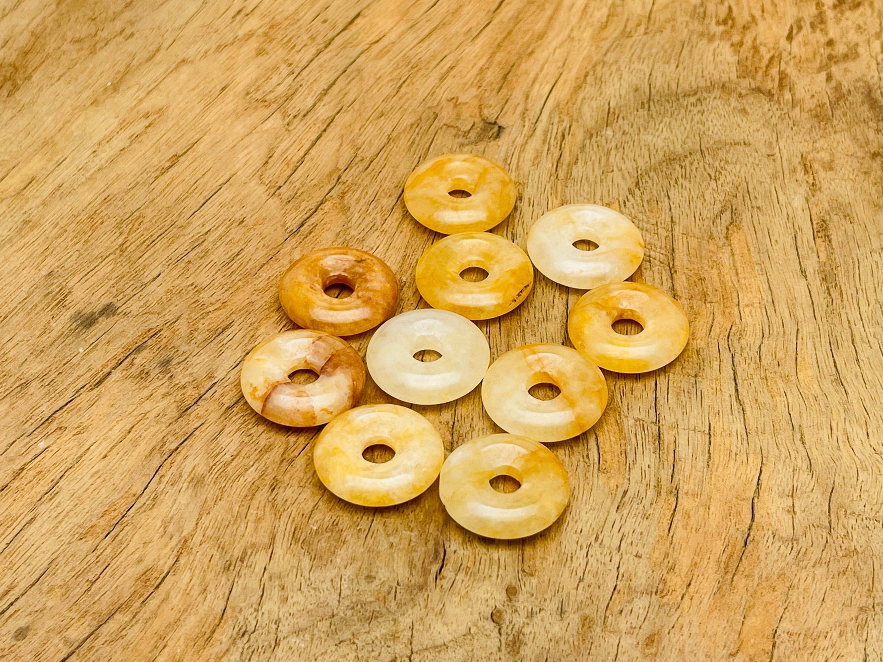 Yellow jade crystal donut pendant, 20mm Pi stone with a smooth, polished surface from GemstoneGO.