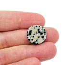 Round Dalmatian Jasper flat gemstone slab from GemstoneGO, showcasing black spots on a light beige background.