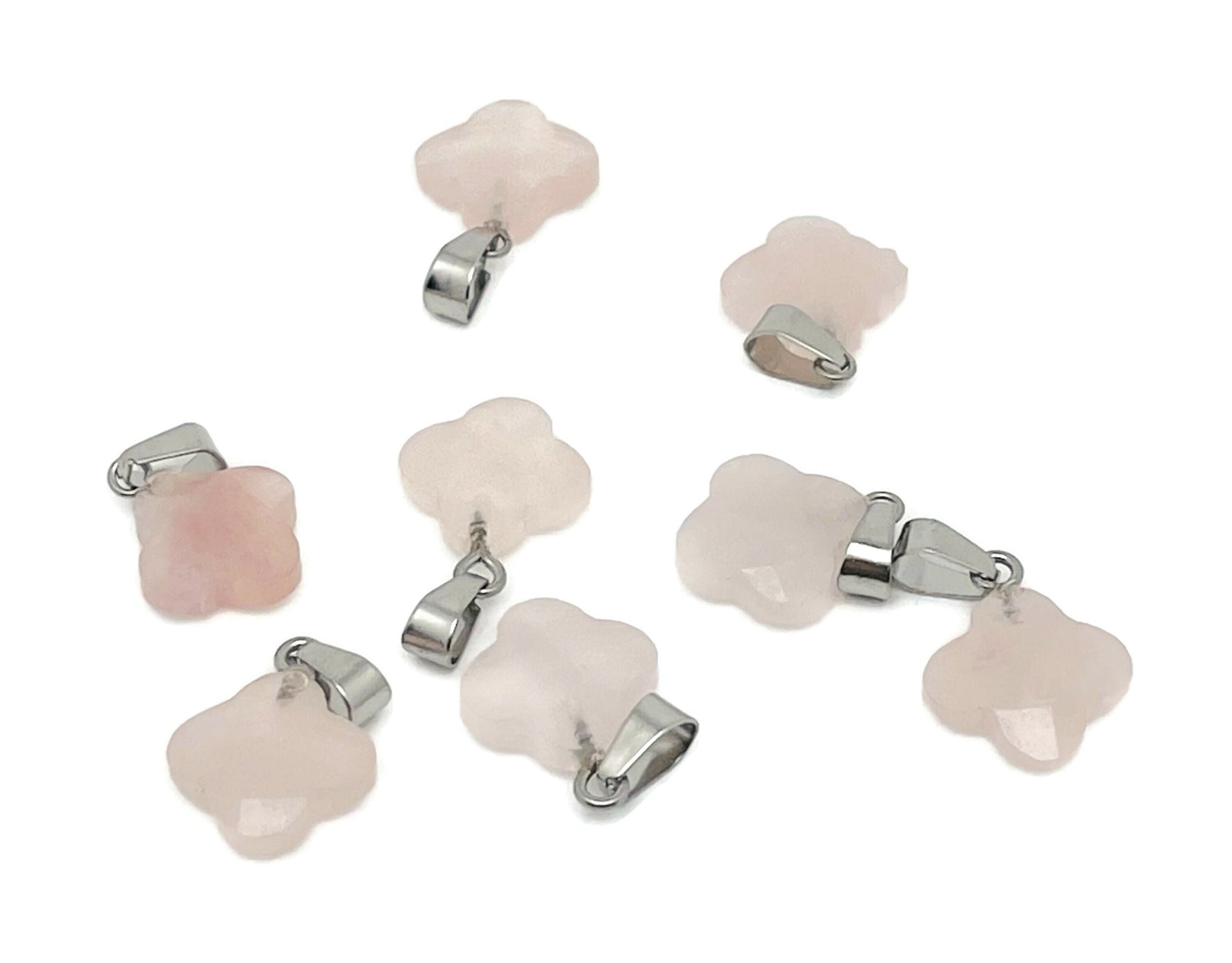 Rose quartz four-leaf clover crystal pendant from GemstoneGO, showing a delicate pink gemstone pendant with a silver loop for jewelry making.
