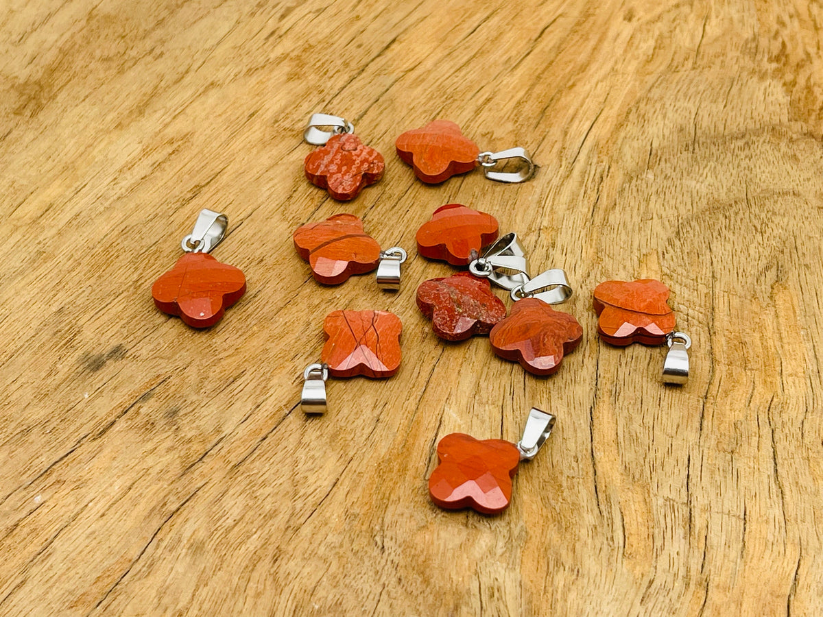 Red Jasper four-leaf clover crystal pendant from GemstoneGO, featuring a vibrant red jasper stone shaped like a four-leaf clover for jewelry making.