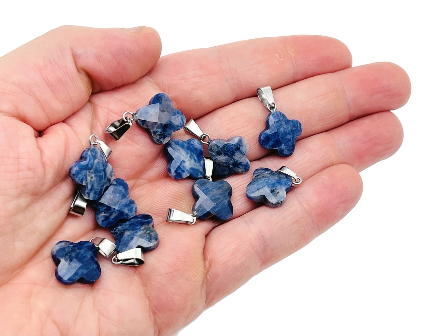 Sodalite four-leaf clover crystal pendant from GemstoneGO, suitable for DIY jewelry making, featuring blue and white gemstone details.