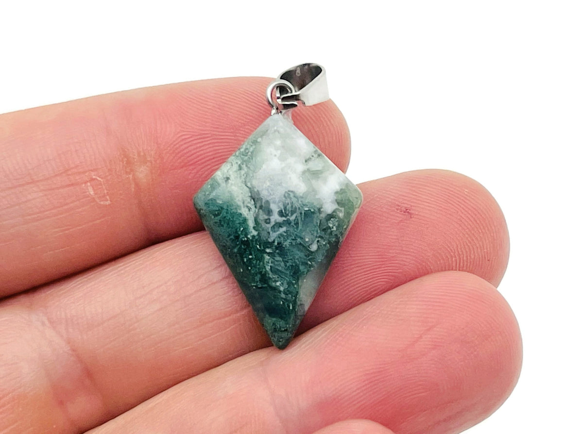 Moss agate triangle gemstone pendant with geometric design, showcasing natural green and brown mineral patterns.