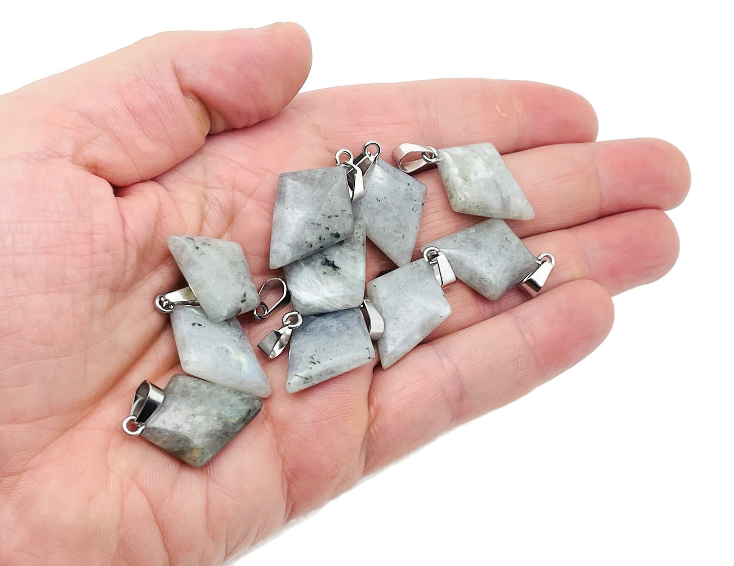 Labradorite triangle gemstone pendant with geometric design, showcasing iridescent colors and polished surface, by GemstoneGO.