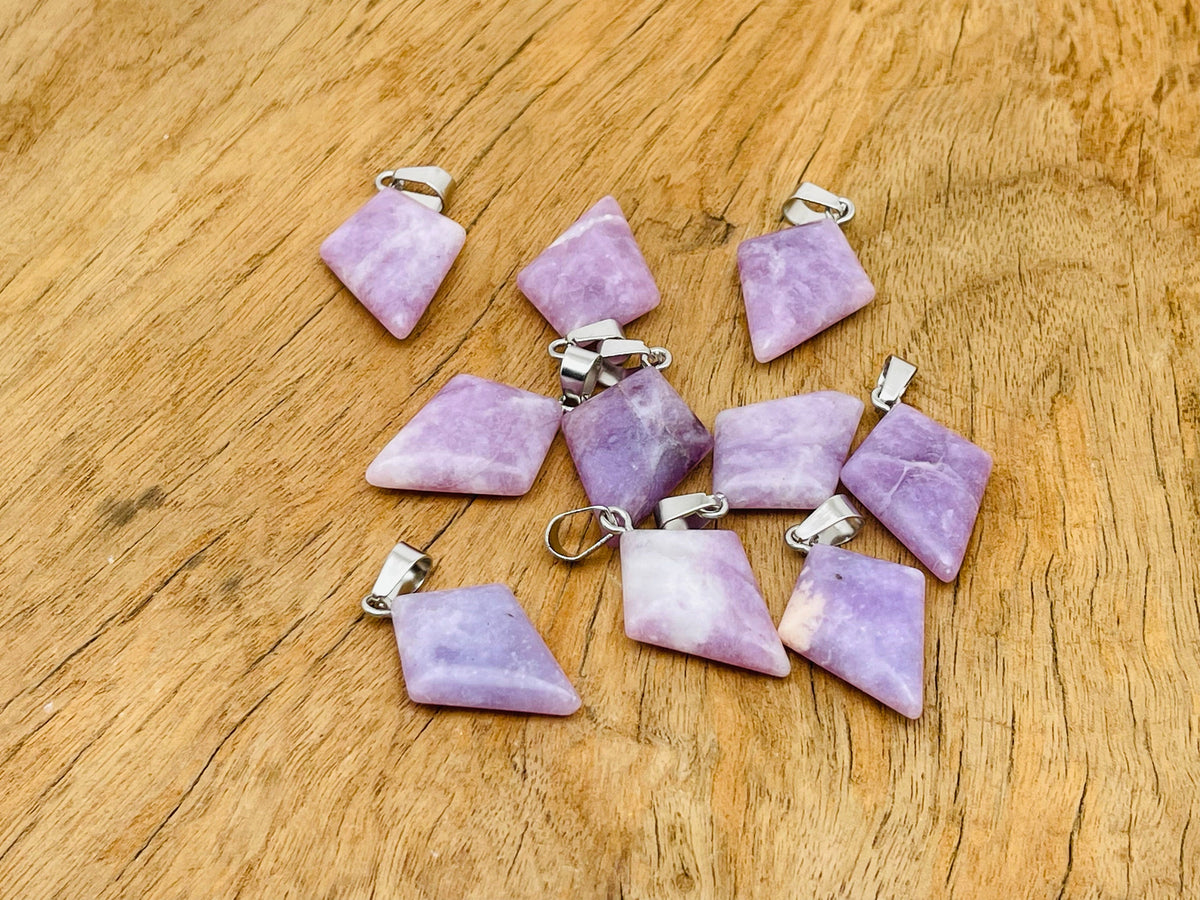 Lepidolite triangle gemstone pendant from GemstoneGO featuring a geometric design and polished surface on a white background.