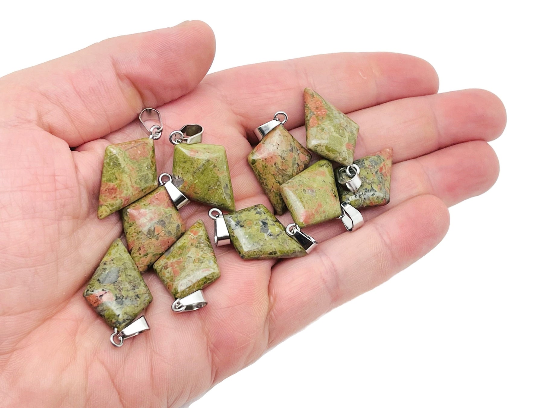 Unakite triangle gemstone pendant from GemstoneGO featuring a geometric design and vibrant green and pink hues.
