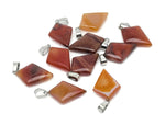 Carnelian triangle gemstone pendant from GemstoneGO featuring a geometric design and vibrant orange-red color.