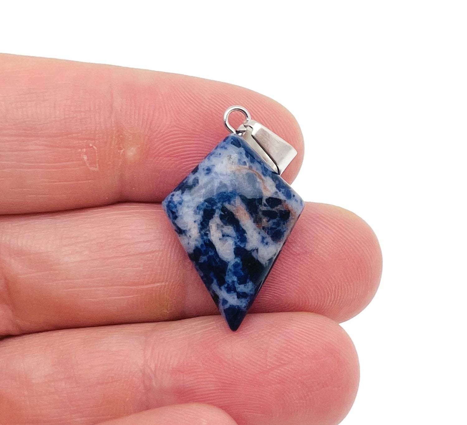 Sodalite triangle gemstone pendant with geometric design by GemstoneGO, showcasing deep blue and white mineral patterns.