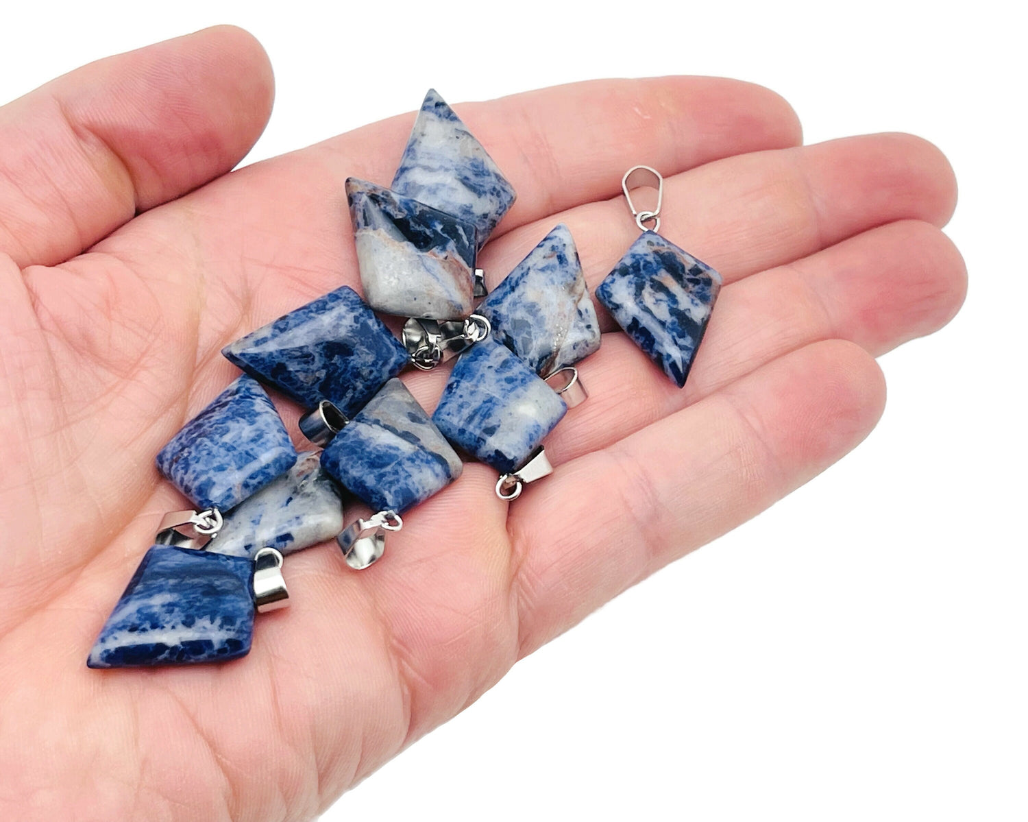 Sodalite triangle gemstone pendant from GemstoneGO featuring a geometric design and vibrant blue color.