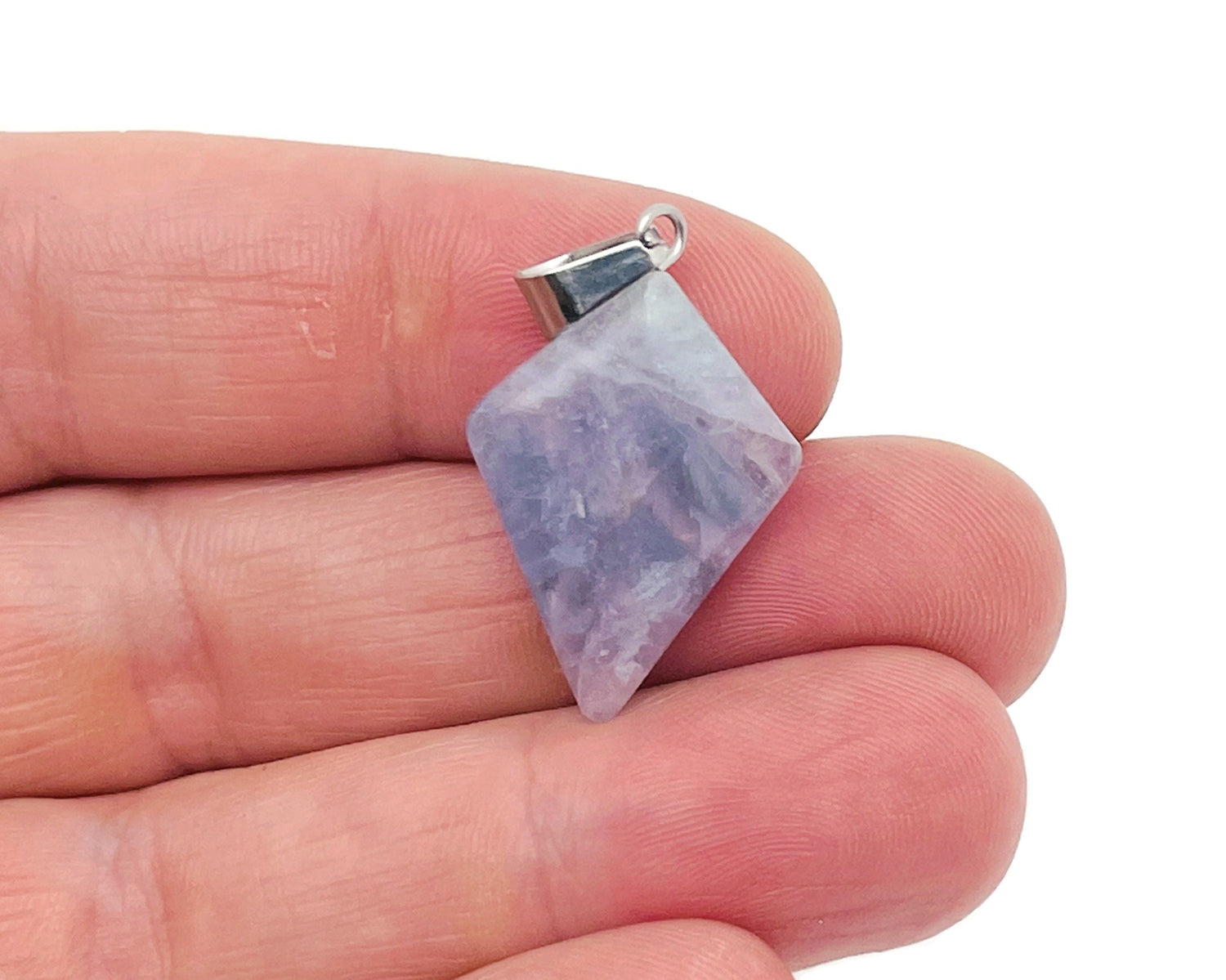 Fluorite triangle gemstone pendant with geometric design, showcasing vibrant colors and polished surface, from GemstoneGO.