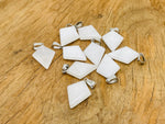 White jade triangle gemstone pendant with geometric design, crafted by GemstoneGO, featuring a smooth, polished finish.