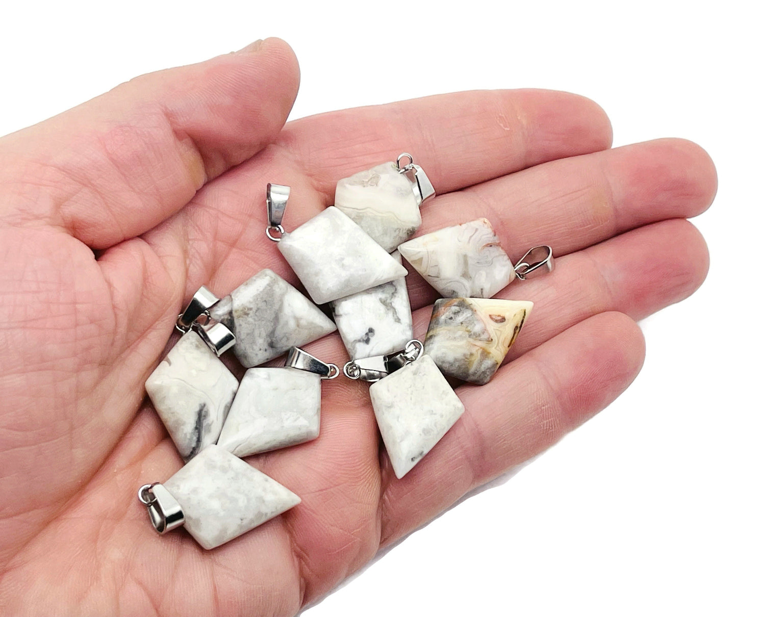 Crazy Lace Agate triangle gemstone pendant with geometric design, showcasing vibrant colors and intricate patterns, from GemstoneGO.