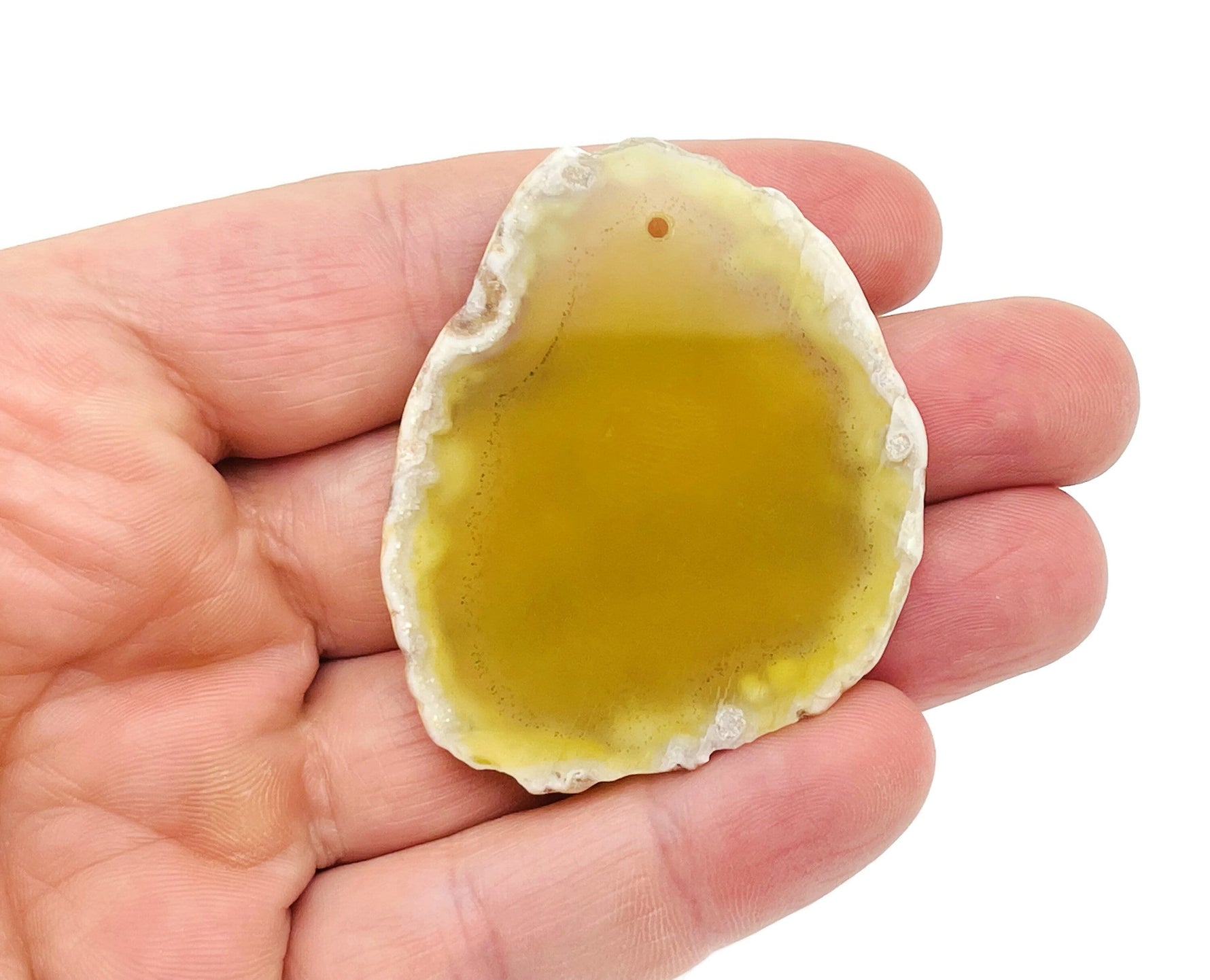Yellow agate slice drilled pendant with natural geode features, showcasing vibrant yellow color and unique crystal interior.