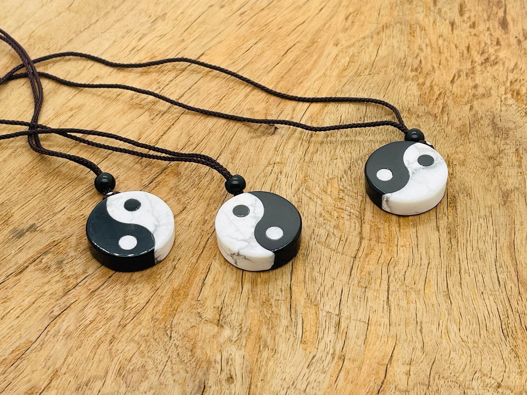 Handmade Yin Yang gemstone necklace featuring Howlite and Obsidian beads, showcasing black and white stone design.