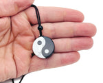 Handmade Yin Yang gemstone necklace featuring Howlite and Obsidian beads with a Yin Yang pendant, showcasing natural stone textures.