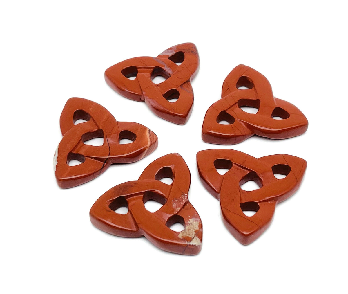 Red Jasper Celtic Knot carved gemstone from GemstoneGO featuring a Trinity Crystal design, showcasing intricate Celtic knot detailing.