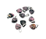 Rhodonite heart-shaped pendant by GemstoneGO featuring a mini crystal design, showcasing vibrant pink and black mineral patterns.