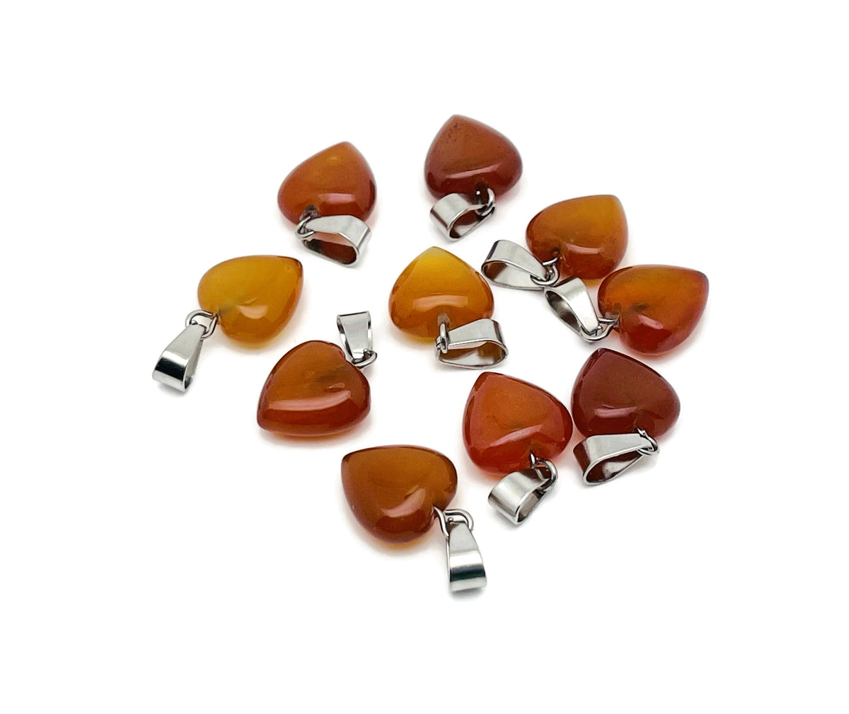 Mini carnelian heart pendant with a crystal accent from GemstoneGO, showcasing a polished orange gemstone heart charm.