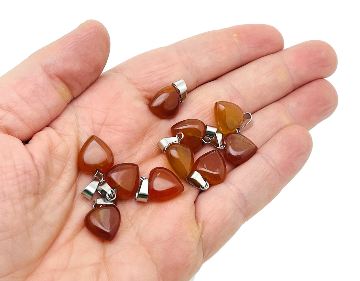 Mini Carnelian Heart Pendant by GemstoneGO featuring a polished gemstone heart crystal on a delicate chain.
