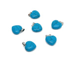 Turquoise heart-shaped pendant with mini crystal accents, gemstoneGO jewelry, close-up of detailed silver setting.