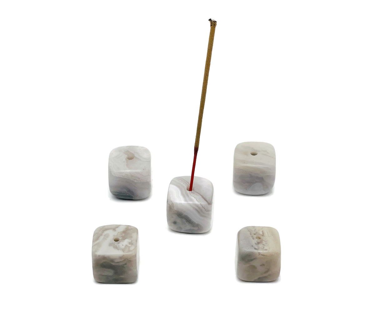 White agate crystal incense holder with handcrafted carving, designed to hold incense sticks securely, showcasing natural stone patterns.