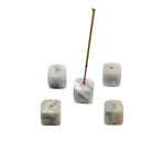 White agate crystal incense holder with handcrafted carving, designed to hold incense sticks securely, showcasing natural stone patterns.