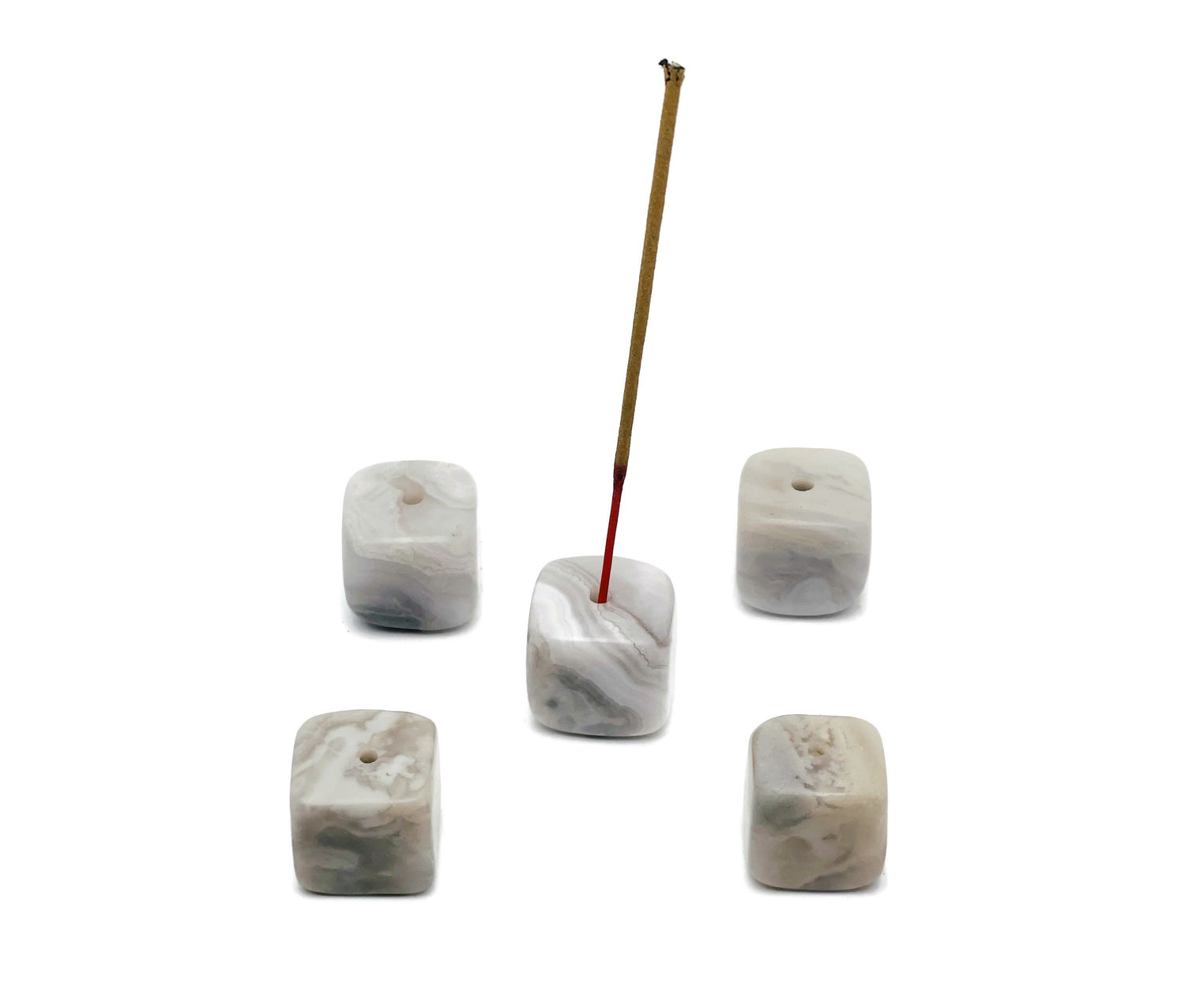 White agate crystal incense holder with handcrafted carving, designed to hold incense sticks securely, showcasing natural stone patterns.