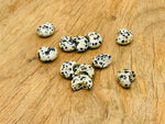 Dalmatian Jasper gemstone moon puffy charm, 15x9mm, with distinctive black spots on cream-colored stone, from GemstoneGO.
