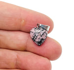Rhodonite heart pendant by GemstoneGO, mini crystal pendant with smooth pink and black marbled gemstone, on a silver chain.