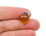 Mini crystal pendant featuring a carved carnelian heart, crafted by GemstoneGO, showcasing vibrant orange gemstone jewelry.
