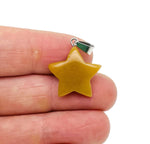 Yellow jade star pendant from GemstoneGO, crystal jewelry making supply with a polished yellow jade star design.