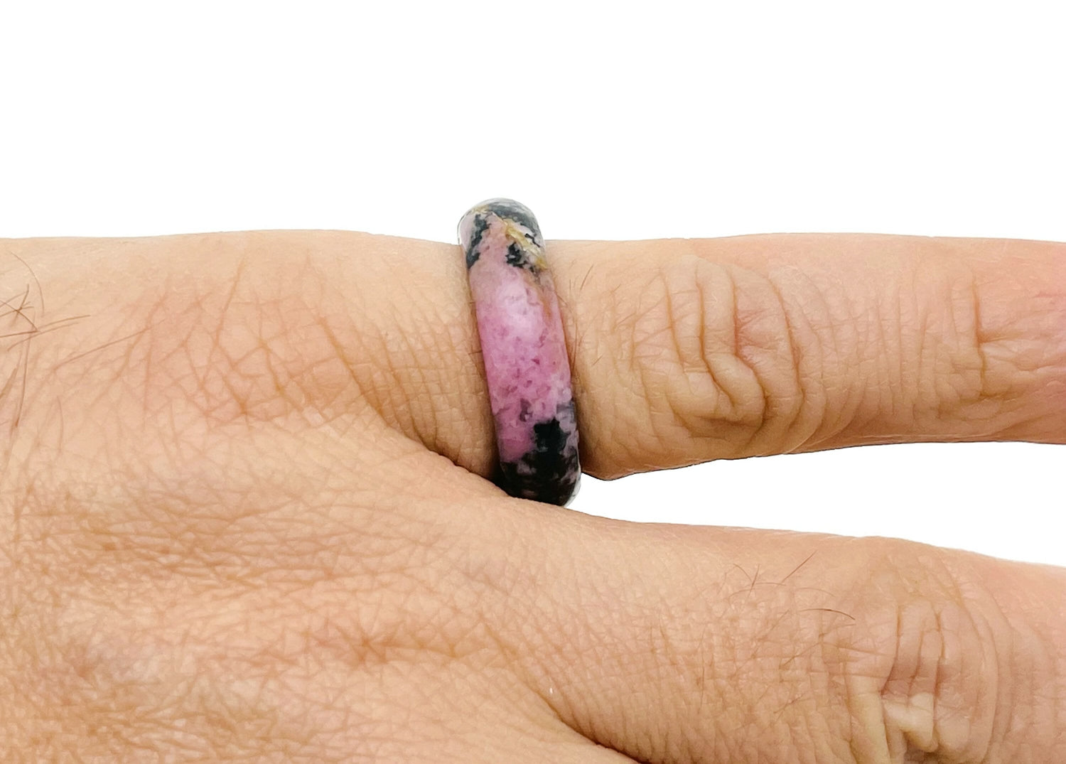 Rhodonite crystal ring by GemstoneGO featuring a polished pink gemstone set in a silver band.