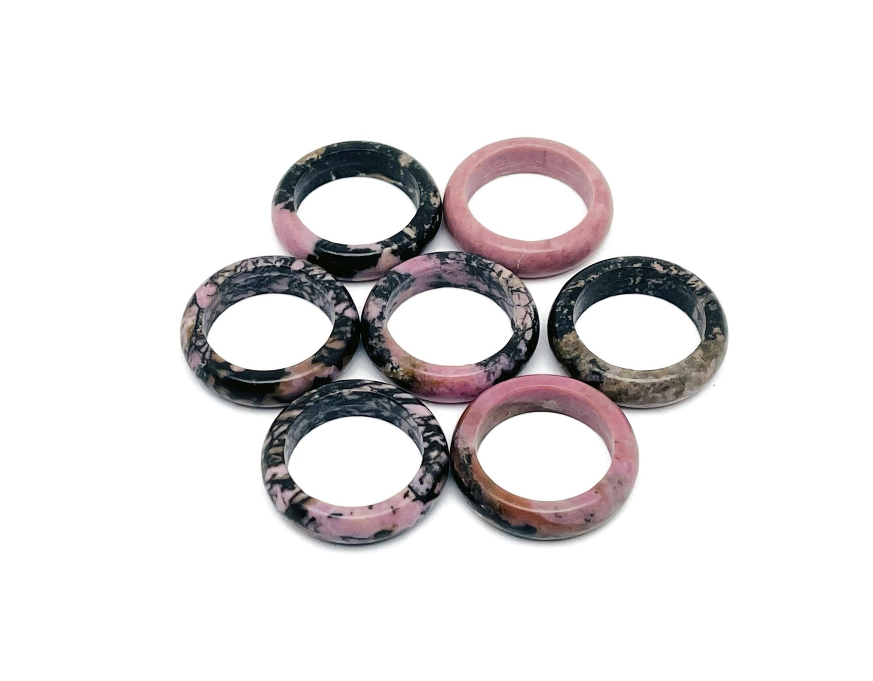 Rhodonite crystal ring by GemstoneGO featuring a polished pink gemstone set in a silver band, showcasing elegant jewelry craftsmanship.