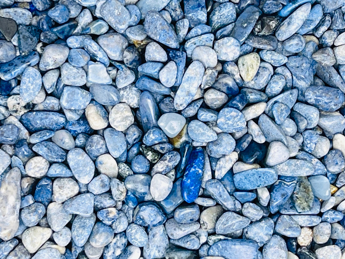 Blue Dumortierite crystal chips, semi-tumbled 5-7mm gemstone stones from GemstoneGO shown in a close-up image.