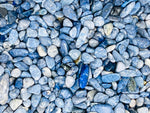 Blue Dumortierite crystal chips, semi-tumbled 5-7mm gemstone stones from GemstoneGO shown in a close-up image.