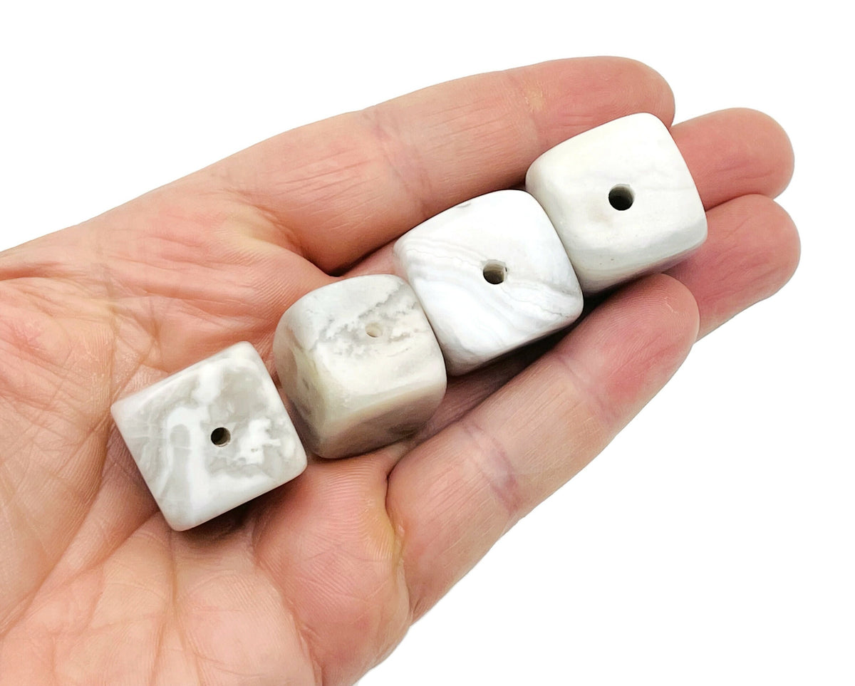 White agate crystal incense holder with hand-carved design, featuring a smooth stone surface and space for incense sticks.