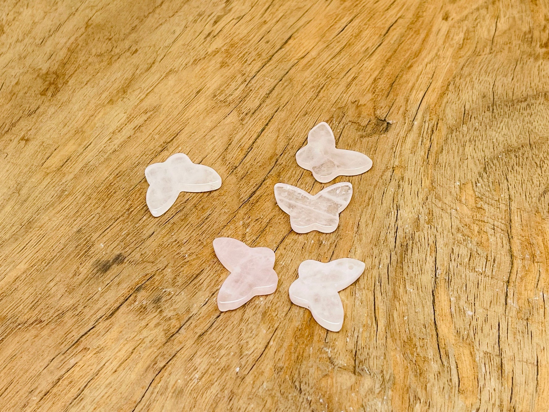 Rose quartz mini butterfly gemstone pendant with hole for jewelry, featuring pink crystal and delicate butterfly design.