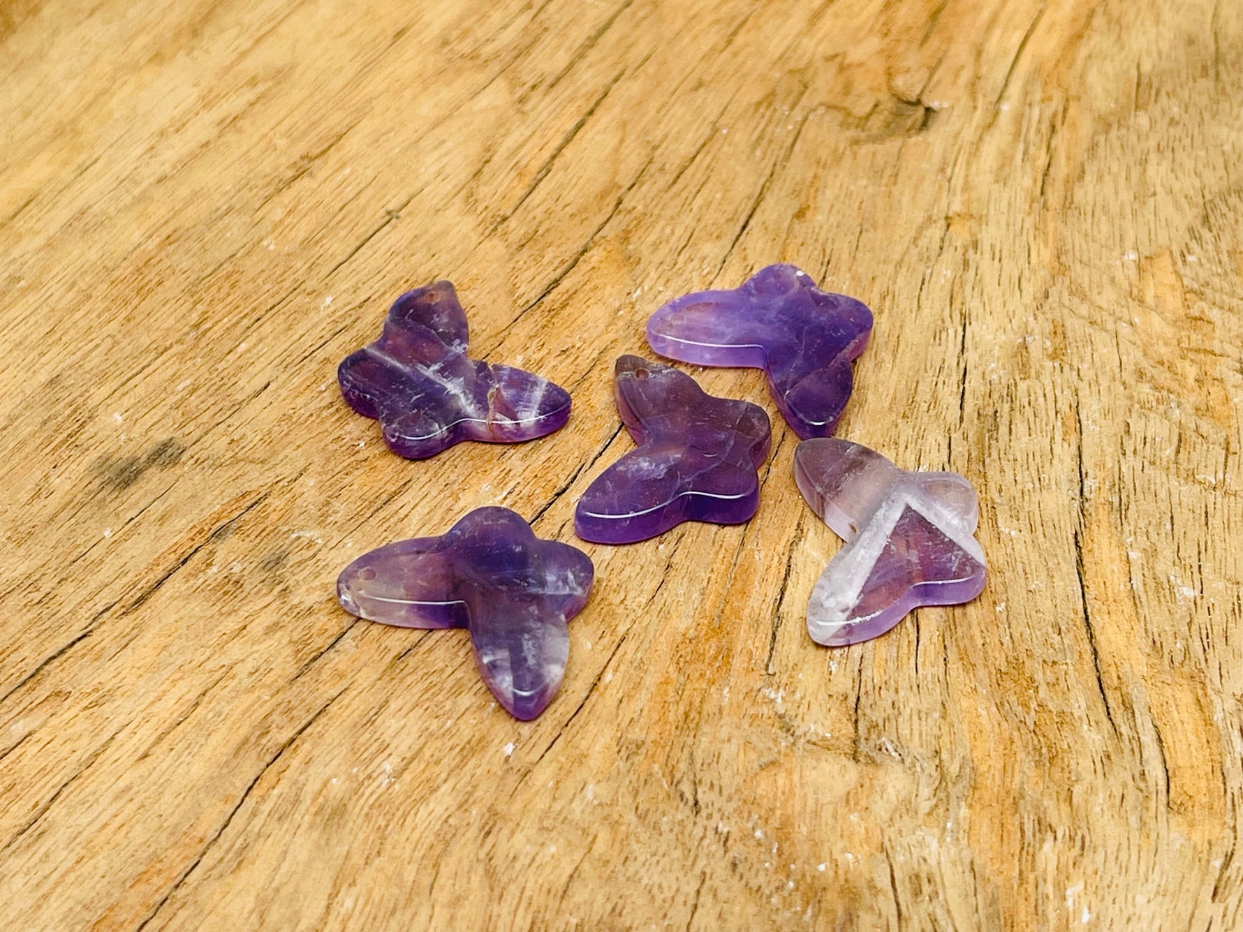 Amethyst mini butterfly gemstone pendant from GemstoneGO featuring a hole crystal jewelry design on a white background.