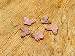 Rhodonite mini butterfly gemstone pendant from GemstoneGO with a hole for jewelry, showcasing pink and black stone details.